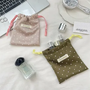Korean polka dot satin drawstring storage bag, silky texture travel makeup pouch organizer.
