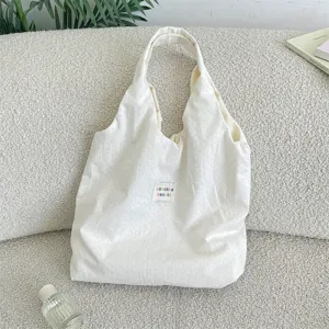 Off-white polka dot canvas shoulder tote bag, casual lazy style everyday bag detail view.