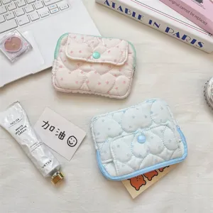 Detail view of quilted card pouch featuring sweet heart pattern, snap button and soft fabric.