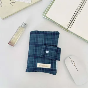 Detail shot of dark green plaid fabric book cover, snap button closure, cute stationery organizer.