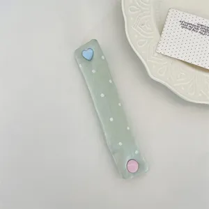 Macaron green polka dot cord organizer strap with cute heart and round snap buttons for cables.