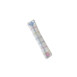 Cute plaid cord organizer with heart snap button for neat cable management and storage.