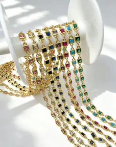 Close-up view of colorful square zircon gold-plated chain detail for DIY jewelry making.