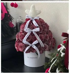 Christmas rose tree gift box with red roses, white hat box and designer ribbons for holiday decor.