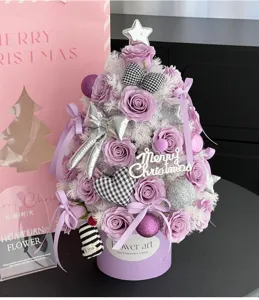 Purple rose artificial Christmas tree gift box with ribbon bows and festive ornaments.