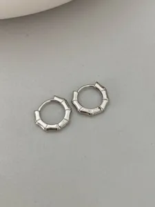 Silver bamboo joint hoop earrings detailed close-up shot showcasing fine metal texture.