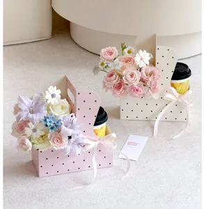 Polka dot milk tea cup flower box with handle, perfect for floral arrangement and gifts.