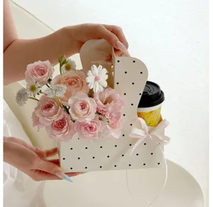 Polka dot milk tea cup flower box detail shot with stunning pink rose bouquet for gift