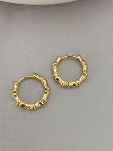 Exquisite gold bamboo joint hoop earrings detail shot, chic minimalist daily commuting jewelry.
