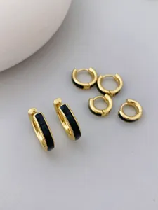 Schicke 18K vergoldete Creolen mit schwarzer Emaileinlage, minimalistische Detailansicht.