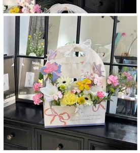 Teacher's day handheld flower box gift packaging box with ribbon handle and floral design.