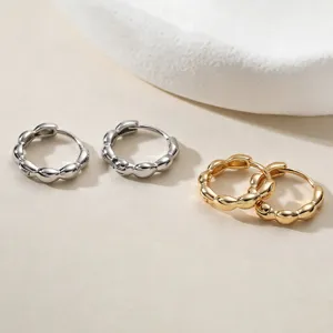 Detailed view of minimalist 18K gold and silver plated geometric hoop earrings.