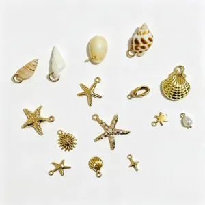 Close-up detail of golden ocean-themed DIY jewelry charms with starfish and shells