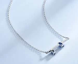 Dettaglio collana in argento, ciondolo a barra orizzontale con gemme blu, gioiello di moda elegante.