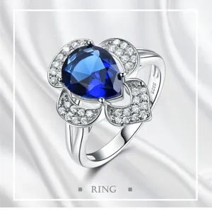 Detailed view of a stunning 925 silver flower ring featuring a pear blue centerpiece and zircon stones.