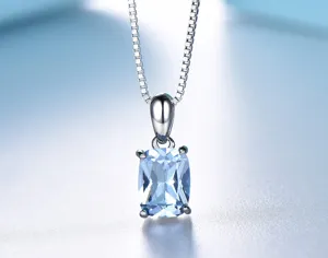 Close-up detail of a rectangular light blue topaz pendant necklace in sterling silver setting.