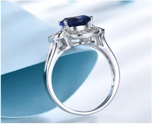 Detailed view of 925 sterling silver ring with deep blue gemstone and sparkling halo stones.