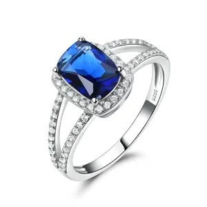 S925 Silberring mit blauem Stein, funkelndem Zirkon Halo und elegantem geteilten Ringschiene.