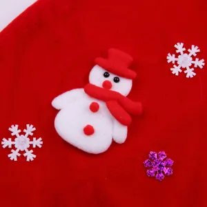 Red velvet Christmas costume detail showing cute snowman and snowflake decorations.