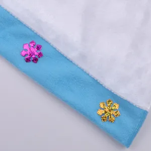 Close up detail of blue and white plush fleece costume fabric with glitter snowflakes.