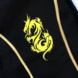 Kids Halloween ninja costume detail showing black fabric, gold trim and yellow dragon print.