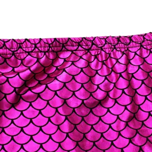 Mermaid scale fabric detail shot of kids swimsuit, glossy pink elastic waistband material.