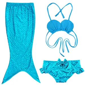 Detailed close-up view of sparkling blue children mermaid swimsuit set with shell top and tail.