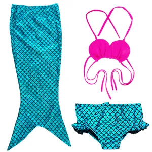 Kids mermaid swimsuit detail featuring sparkly blue tail skirt and pink shell bikini top.