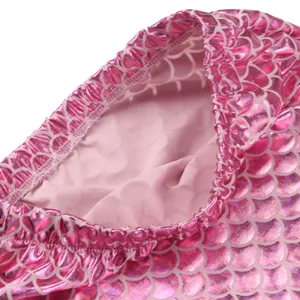 Kids pink mermaid swimsuit detail shot, holographic fish scale fabric with elastic waistband.