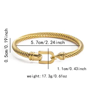 Gold twisted cable bracelet with horseshoe U-shackle clasp, elegant titanium steel fashion jewelry.