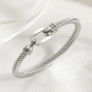 Silver twisted cable bracelet with a unique U-shaped horseshoe clasp for minimalist luxury.
