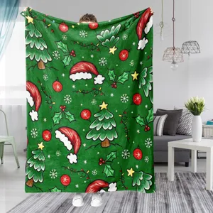 Christmas fleece blanket detail showcasing cozy green fabric with festive holiday tree patterns.