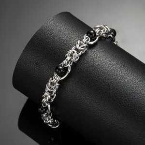 Close-up of stainless steel black agate chain bracelet, punk hip hop style detail shot.