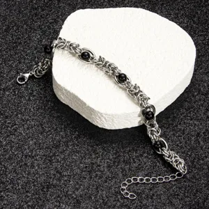 Stainless steel chain bracelet detail featuring polished black beads and secure clasp.