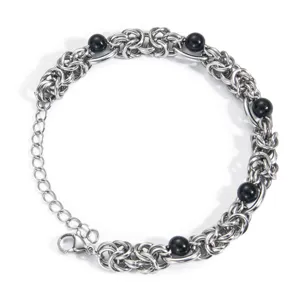 Close-up of stainless steel Byzantine chain bracelet with black beads and lobster clasp.