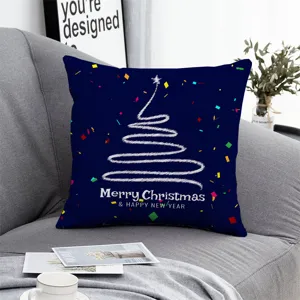 Detailed view of a navy blue Christmas throw pillow with white sketch tree and holiday text.