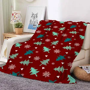 Christmas flannel blanket featuring festive trees and snowflakes, cozy home sofa decor.