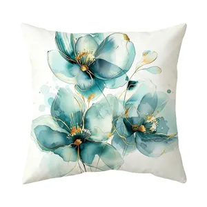 Detail view of a watercolor teal floral throw pillow cover with elegant gold accents.