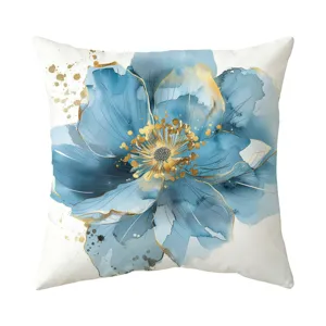 Blue watercolor floral pillow cover detail, gold ink splatter accent, home decor aesthetic.
