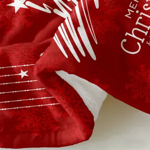 Detailed close-up of soft red flannel Christmas blanket with white snowflake pattern.