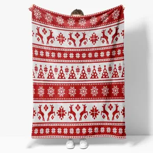 Close-up of a festive red and white Nordic pattern Christmas fleece blanket with reindeer.