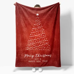 Detailed view of a soft red flannel Christmas blanket featuring a white abstract tree print.