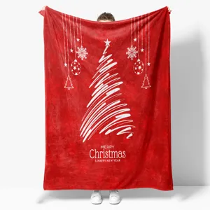 Detailed view of red Christmas flannel blanket with white tree pattern and festive text.
