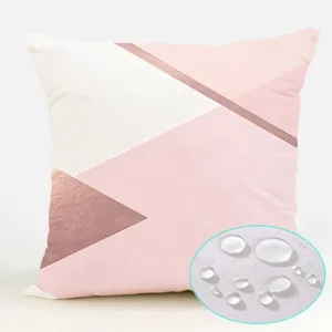 Pink geometric waterproof polyester throw pillow cover detail showing water resistance.