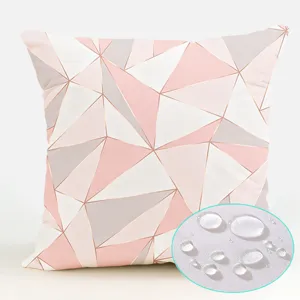Waterproof pink geometric cushion cover detail, soft polyester fabric texture close up.