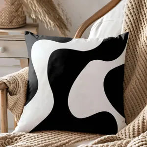 Housse de coussin décorative géométrique abstraite noire et blanche pour salon et canapé.