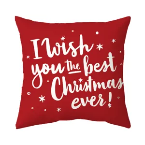 Decorative Christmas red pillow cover with white festive text and snowflakes for holiday sofa.