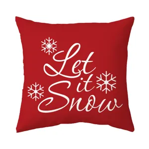 Festive red throw pillow cover with white Let it Snow text and snowflake design for sofa.