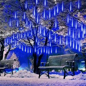 Outdoor LED meteor shower string light scene showing bright blue hanging tubes in snowy winter.