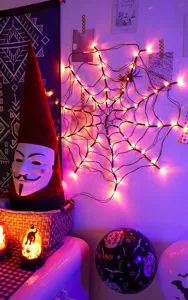 Halloween purple spider web LED string light detail view, spooky holiday atmosphere decor.